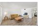 Living room featuring wood-look floors, neutral walls, and comfortable furniture at 11700 Park Blvd # 202, Seminole, FL 33772