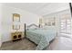 Main bedroom with wood-look floors, neutral walls, and a window for natural light at 11700 Park Blvd # 202, Seminole, FL 33772