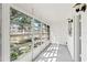 Bright, airy screened balcony with large windows showcasing a green landscape and white accents throughout at 11700 Park Blvd # 202, Seminole, FL 33772