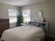 Cozy bedroom featuring two bright windows and light colored walls, creating a serene space at 126 E Center St, Tarpon Springs, FL 34689