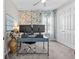 Bright home office with floral wallpaper, gray carpet, dual monitors, and ample natural light at 13227 Wildflower Meadow Dr, Riverview, FL 33579