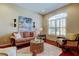 Cozy living room featuring a large window with plantation shutters at 14813 Princewood Ln, Land O Lakes, FL 34638