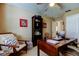 Home office featuring a ceiling fan, built-in bookcase, and a dark wooden desk at 14813 Princewood Ln, Land O Lakes, FL 34638