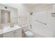 Neat bathroom with shower-tub combination, single sink vanity and a wall mirror at 1515 Danbury Dr, Sun City Center, FL 33573