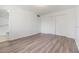 A well-lit bedroom with wood floors, a closet, and white walls at 1515 Danbury Dr, Sun City Center, FL 33573