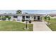Charming single-story home with well-kept lawn, decorative bushes, and covered front entry at 1515 Danbury Dr, Sun City Center, FL 33573