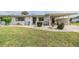 Charming single-story home with well-kept lawn, decorative bushes, and attached carport at 1515 Danbury Dr, Sun City Center, FL 33573