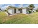 Exterior view of a charming home featuring dual entry doors and beautiful landscaping at 1515 Danbury Dr, Sun City Center, FL 33573