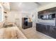 Well-lit kitchen with black appliances, wood countertops, and tiled floor, alongside laundry area at 1515 Danbury Dr, Sun City Center, FL 33573