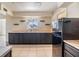 Spacious kitchen featuring dark cabinets, tile flooring, and stainless steel appliances at 1515 Danbury Dr, Sun City Center, FL 33573