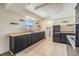 Spacious kitchen featuring dark cabinets, tile flooring, and laundry room in the background at 1515 Danbury Dr, Sun City Center, FL 33573