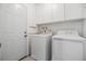 Practical laundry room with washer, dryer, and storage cabinets for convenience at 1515 Danbury Dr, Sun City Center, FL 33573