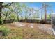 Large, partially fenced backyard with mature trees providing shade and privacy for outdoor enjoyment at 15165 Waverly St, Clearwater, FL 33760