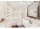 Bathroom with white tile, a shower/tub combo, and built-in shelving at 15165 Waverly St, Clearwater, FL 33760