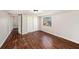 Bedroom featuring wood floors, a window, and a sliding door closet at 15165 Waverly St, Clearwater, FL 33760