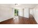 This bedroom has wood flooring, closet, and sliding glass doors that lead to the backyard at 15165 Waverly St, Clearwater, FL 33760