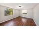 Bright bedroom features wood floors and natural light from two windows at 15165 Waverly St, Clearwater, FL 33760