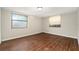 This bedroom has wood flooring and two windows that let in natural light at 15165 Waverly St, Clearwater, FL 33760