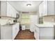 Cozy kitchen featuring white appliances, plenty of cabinet space and modern lighting at 15165 Waverly St, Clearwater, FL 33760