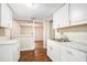 Modern kitchen with white cabinetry, updated countertops, and an open view to the living area at 15165 Waverly St, Clearwater, FL 33760