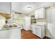 Well-lit kitchen featuring white cabinets, modern appliances, and functional layout at 15165 Waverly St, Clearwater, FL 33760