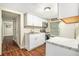 Efficient kitchen space with white cabinets, appliances, and contemporary finishes at 15165 Waverly St, Clearwater, FL 33760