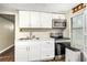 Updated kitchen featuring white cabinets, stainless steel appliances, and modern countertops at 15165 Waverly St, Clearwater, FL 33760