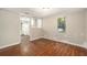 Open-concept living area showing wood-look floors and a glimpse into the updated kitchen at 15165 Waverly St, Clearwater, FL 33760