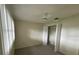 Neutral bedroom with ceiling fan, closet and ample natural light at 1567 Patton Dr, Dunedin, FL 34698