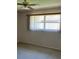 Bedroom featuring ceiling fan and bright window at 1567 Patton Dr, Dunedin, FL 34698