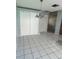 Bright dining area with tile flooring, closet, and a modern chandelier at 1567 Patton Dr, Dunedin, FL 34698