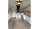 Functional garage space with washer, dryer, and plenty of storage, plus ceiling access with ladder at 1567 Patton Dr, Dunedin, FL 34698