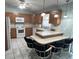 Eat-in kitchen featuring wood cabinets, white appliances, and a ceiling fan at 1567 Patton Dr, Dunedin, FL 34698