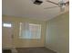 Inviting living room with a ceiling fan, neutral paint, and natural light streaming through the large window at 1567 Patton Dr, Dunedin, FL 34698