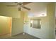 Living room with high ceilings, a fan and a mirror at 1567 Patton Dr, Dunedin, FL 34698
