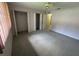 Spacious main bedroom with large closets, neutral carpet, and a ceiling fan at 1567 Patton Dr, Dunedin, FL 34698