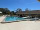 Community pool with a hot tub and ample seating, ideal for entertaining or unwinding after a long day at 1567 Patton Dr, Dunedin, FL 34698