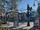 Scenic street view featuring informational signage, vintage streetlights, and lush greenery at 1567 Patton Dr, Dunedin, FL 34698