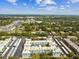 Expansive aerial shot of the condo complex nestled among verdant trees in a vibrant community at 1706 Belleair Forest Dr # 314, Belleair, FL 33756