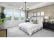 Serene main bedroom with tray ceilings, picture windows, textured wall, and luxury decor at 18264 Chromata Dr, Venice, FL 34293
