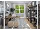 Well-lit study featuring a modern desk, shelving unit, and a comfortable area rug at 18264 Chromata Dr, Venice, FL 34293