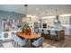 Open-concept dining area with modern lighting fixture and seamless transition into the gourmet kitchen at 18604 Arbor Vista Dr, Venice, FL 34293