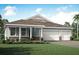 Charming single-story home showcasing stone accents and a two-car garage, nestled on a well-manicured lawn at 18604 Arbor Vista Dr, Venice, FL 34293