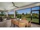 Relaxing outdoor patio with ceiling fans, and a dining set overlooking lush landscaping and green spaces at 18604 Arbor Vista Dr, Venice, FL 34293