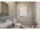 Tastefully designed powder room featuring a modern sink, toilet, and stylish decor at 18604 Arbor Vista Dr, Venice, FL 34293