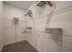 White walk-in closet with shelving, storage boxes, and hanging racks for optimal organization at 18604 Arbor Vista Dr, Venice, FL 34293