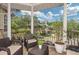 Spacious covered balcony includes comfortable seating and potted plants, perfect for outdoor enjoyment at 2308 W Jetton Ave, Tampa, FL 33629