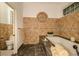 Detailed bathroom featuring a soaking tub with beige tile and glass block window at 2308 W Jetton Ave, Tampa, FL 33629