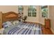 Bright bedroom featuring large windows, a desk, and hardwood floors at 2308 W Jetton Ave, Tampa, FL 33629