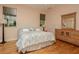 Well lit bedroom with a plush bed and dresser at 2308 W Jetton Ave, Tampa, FL 33629